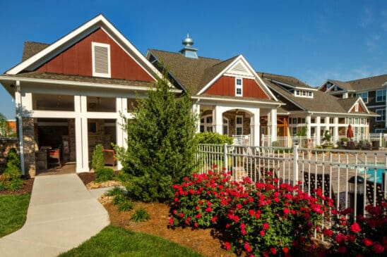 Apartment clubhouse with landscaped garden and pool area