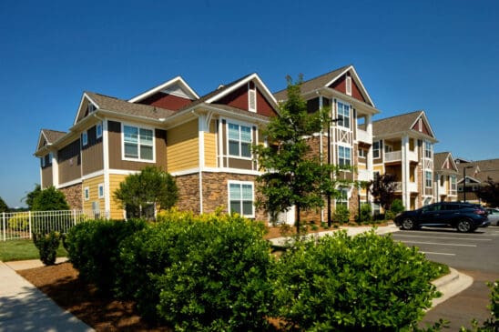 Modern apartment complex with parking and landscaping