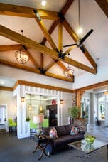 Modern living room with exposed wooden beams and fan