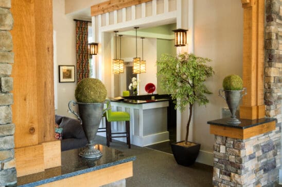 Rustic entryway with exposed beams and stone columns