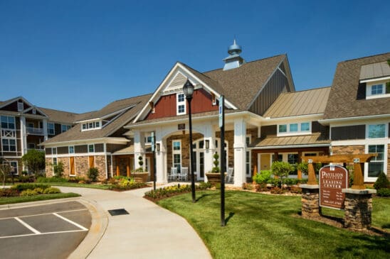 Apartment community leasing center exterior with landscaped entrance