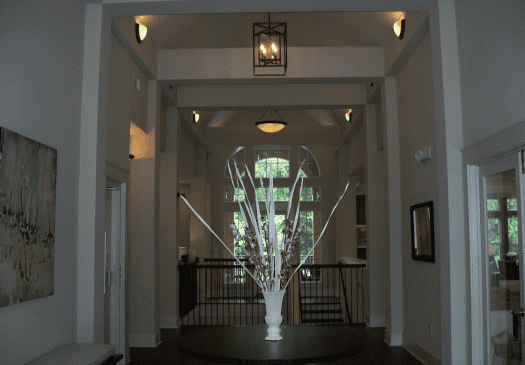 Elegant hallway with tall ceilings and decorative vase