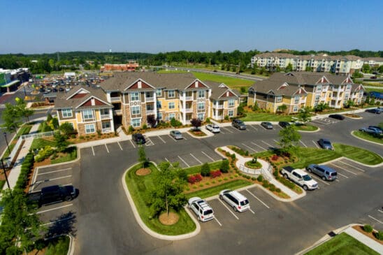Aerial view of modern apartment complex and parking lot