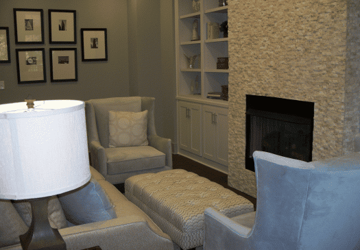 Cozy living room with armchairs and stone fireplace