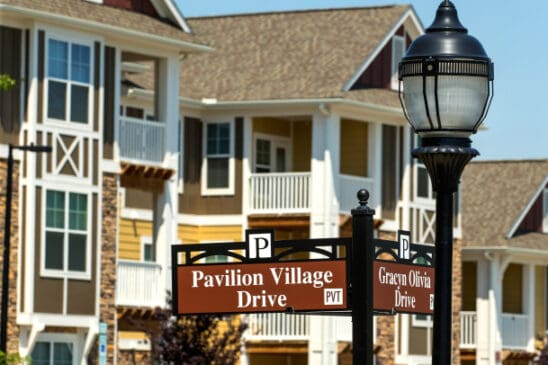 Apartment complex with Pavilion Village Drive sign