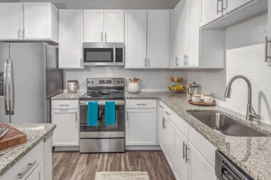 Modern white kitchen with stainless steel appliances