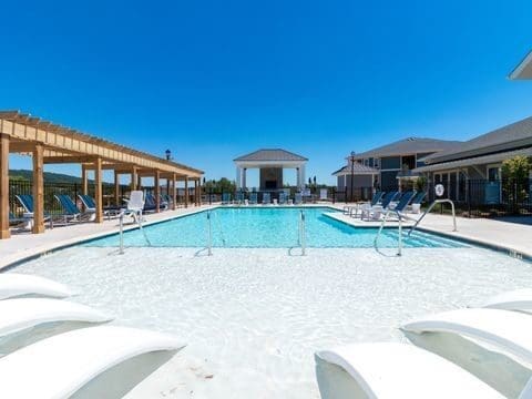Resort-style outdoor swimming pool with lounge chairs