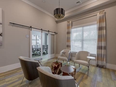 Modern office waiting area with chairs and glass doors
