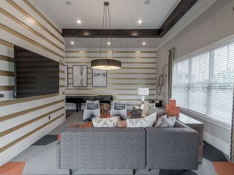 Modern living room with striped walls and gray sofa