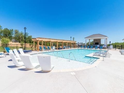 Outdoor swimming pool with lounge chairs and pergola