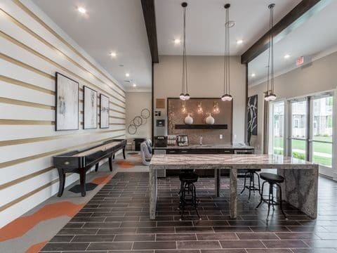 Modern communal kitchen with island and pendant lights