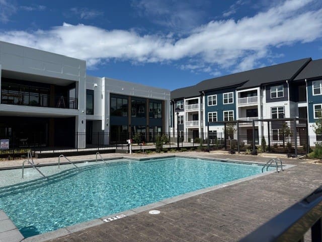 Modern apartment complex with outdoor swimming pool