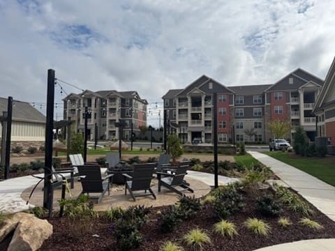 Apartment complex courtyard with fire pit and seating
