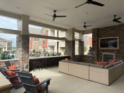 Covered outdoor patio with seating and fireplace