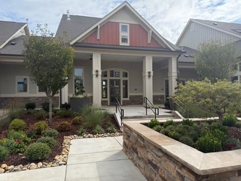 Modern suburban house with landscaped front yard and porch