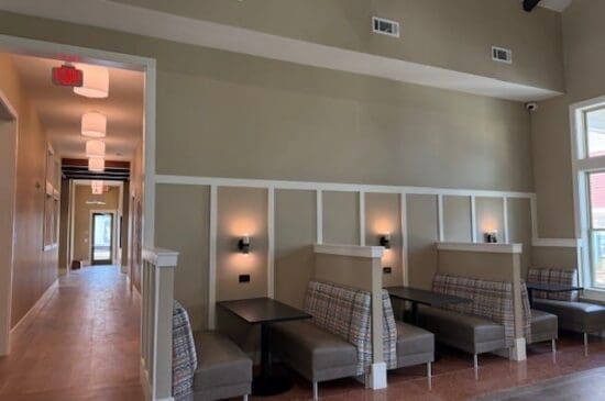 Modern hallway with booth seating and wall sconces