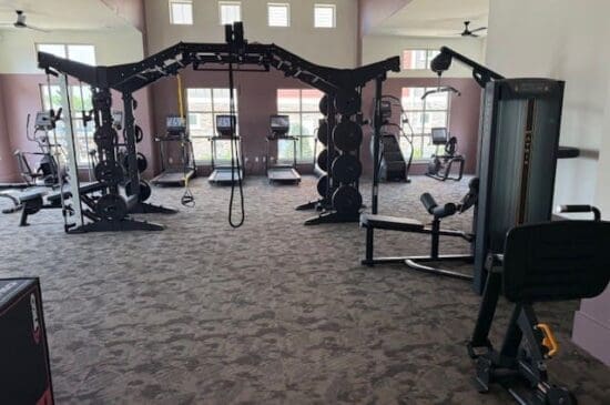 Spacious gym with cable machines and treadmills