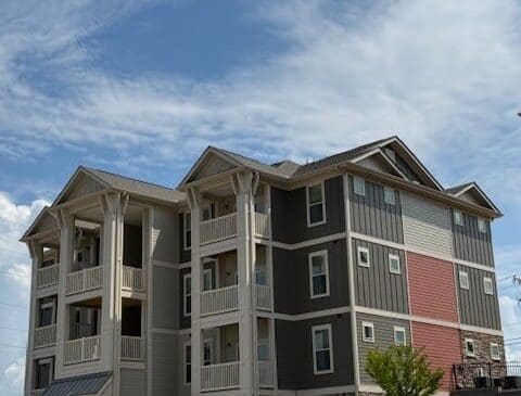 Three-story modern apartment building with balconies